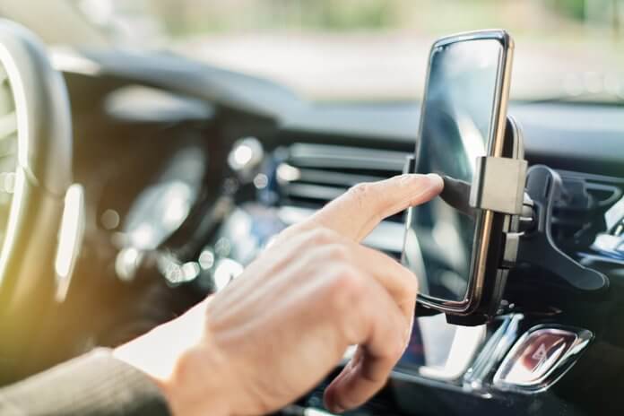 Man using smart phone in car